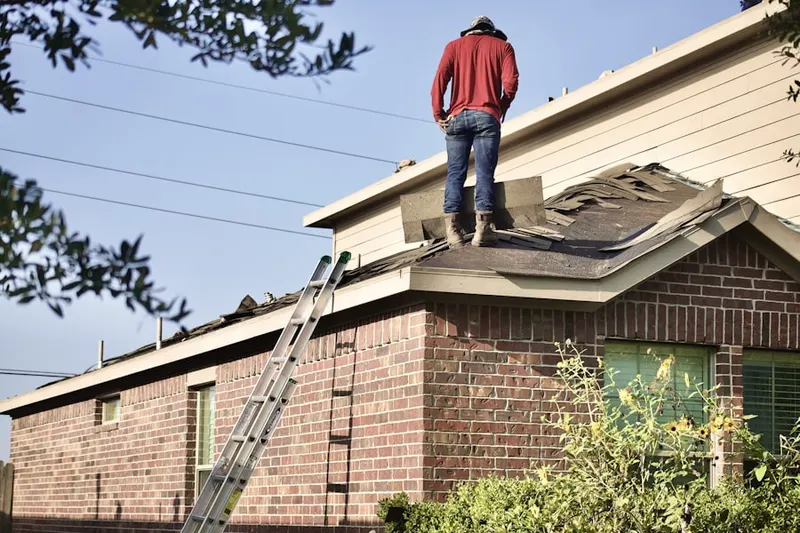 Professional roofer working on a residential roof in Northwest Bellevue